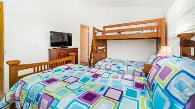 a bedroom with a bed with a colorful comforter at 7652 Otterspool in Kissimmee