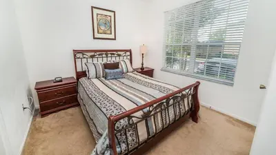 a bedroom with a bed and a window at 7652 Otterspool in Kissimmee