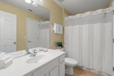 a bathroom with a white sink and a toilet at 2605 Pawnall in Kissimmee