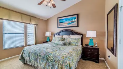 a bedroom with a bed and two lamps and a window at 2540 Renshaw in Kissimmee