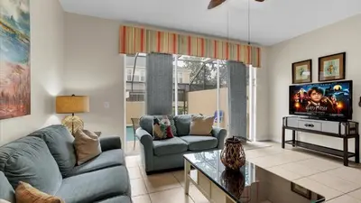 a living room with a couch and a tv at 7653 Sir Kaufmann in Kissimmee