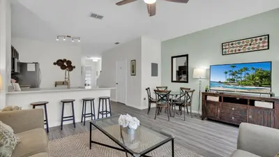 a living room with a couch and a kitchen and a tv at 7679 Sir Kaufman in Kissimmee