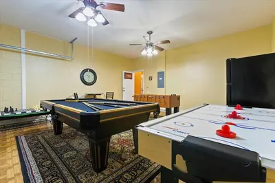 a room with a pool table and ping pong tables at 7718 Teascone in Kissimmee
