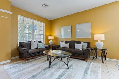 a living room with two couches and a table at 7718 Teascone in Kissimmee