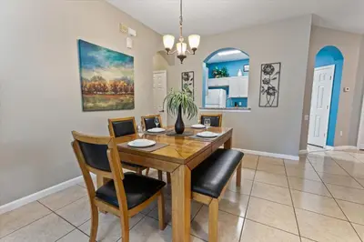 a dining room with a wooden table and chairs at 8107 Coconut Palm #305 in Kissimmee