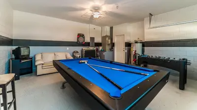 a living room with a pool table in it at 8147 Fan Palm in Kissimmee