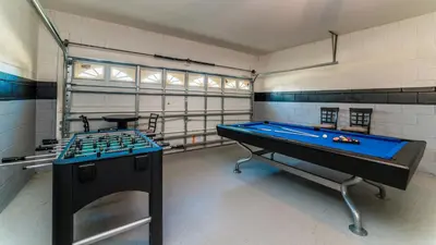 a gym with two pool tables in a room at 8147 Fan Palm in Kissimmee