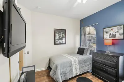 a bedroom with a bed and a tv in it at 8157 Fan Palm in Kissimmee