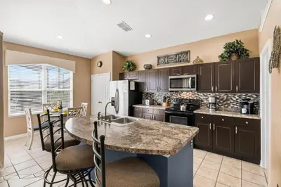 a kitchen with a large island in a room at 8157 Fan Palm in Kissimmee