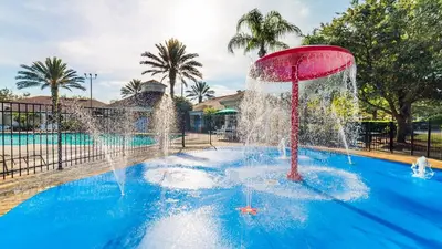 a fountain in the middle of a swimming pool at 8159 Fan Palm in Kissimmee