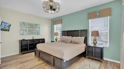 a bedroom with a large bed and two night stands at 8176 Fan Palm in Kissimmee