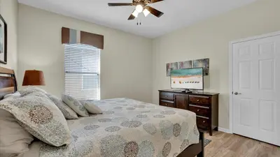 a bedroom with a bed and a ceiling fan at 8176 Fan Palm in Kissimmee