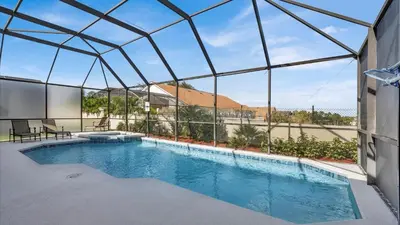 a swimming pool inside of a building with a glass ceiling at 8176 Fan Palm in Kissimmee