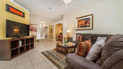 a living room with a couch and a television at 8190 Fan Palm in Kissimmee