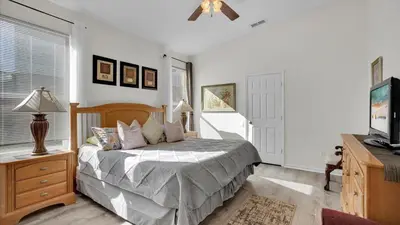 a bedroom with a bed and a flat screen tv at 8034 King Palm in Kissimmee