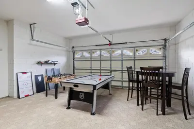 a room with a ping pong table and chairs at 8034 King Palm in Kissimmee