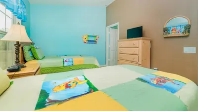 a bedroom with two beds and a dresser at 8114 Princess Palm in Kissimmee