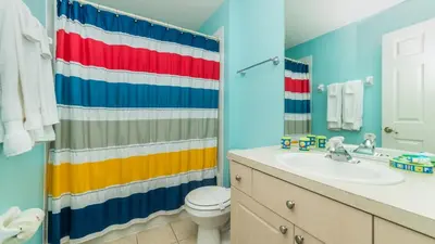 a bathroom with a rainbow shower curtain and a sink at 8114 Princess Palm in Kissimmee