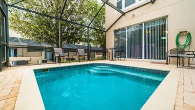 a swimming pool in front of a building at 8114 Princess Palm in Kissimmee