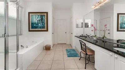 a bathroom with a tub and two sinks and a bath tub at 8136 Sun Palm in Kissimmee