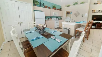 a kitchen and dining room with a table and chairs at 8137 Sun Palm in Kissimmee