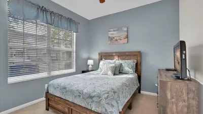 a bedroom with a bed and a television and a window at 2326 Silver Palm in Kissimmee