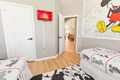 a bedroom with two beds and a tv on the wall at 2209 Wyndham Palms in Kissimmee