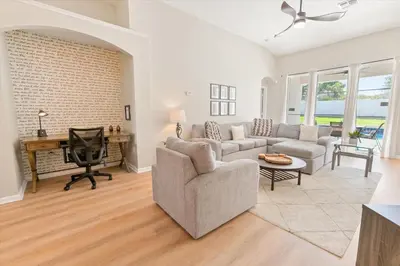 a living room with a couch and a desk at 2209 Wyndham Palms in Kissimmee