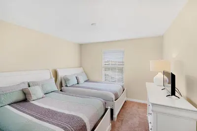 a bedroom with two beds and a television in it at 8883 Candy Palm in Kissimmee
