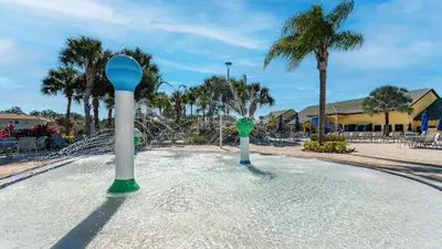 a pool of water with two poles in the middle at 8883 Candy Palm in Kissimmee