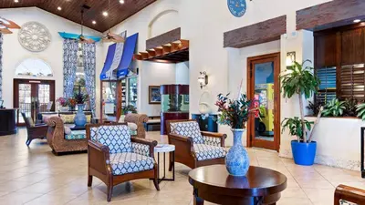 a lobby of a hotel with chairs and tables at 8949 Candy Palm in Kissimmee