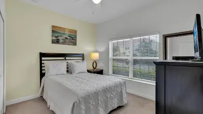 a bedroom with a bed and a window at 8967 Cat Palm in Kissimmee