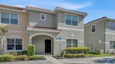 a house in a villa with a driveway at 8967 Cat Palm in Kissimmee