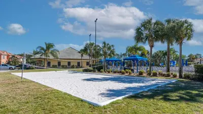 a playground with blue umbrellas and palm trees at 8951 Coco Palm in Kissimmee