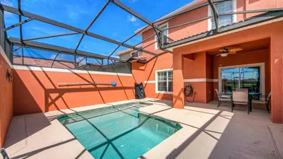 a house with a swimming pool in the courtyard at 8946 Cuban Palm in Kissimmee