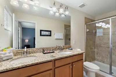 a bathroom with two sinks and a shower at 8949 Cuban Palm in Kissimmee