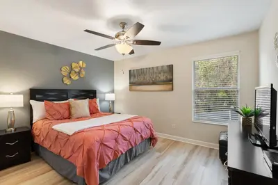 a bedroom with a bed and a ceiling fan at 8949 Cuban Palm in Kissimmee