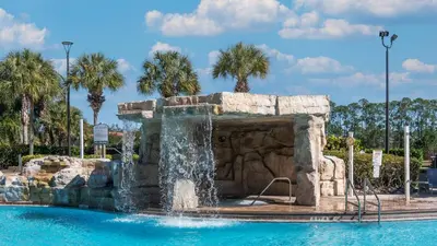 a fountain in the middle of a swimming pool at 8968 Cuban Palm in Kissimmee