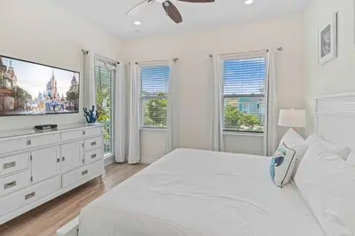 a white bedroom with a large bed and windows at 8000 Lost Shaker Lane in Orlando