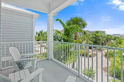 a balcony with a table and chairs and palm trees at 8000 Lost Shaker Lane in Orlando