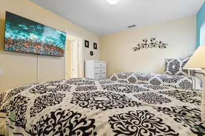 a bedroom with a bed and a painting on the wall at 2638 Dinville in Orlando