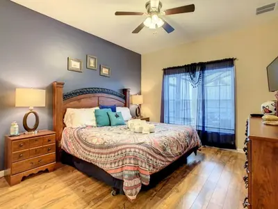 a bedroom with a bed and a ceiling fan at Beautiful Windsor Palms 4 Bed South Facing Pool villa in Kissimmee