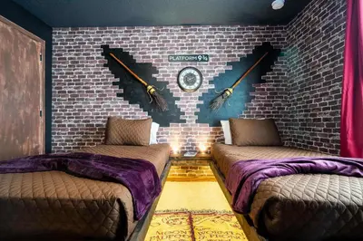 a room with two beds and a brick wall at Marvelous 3Bd Close to Disney w GameRoom at The Hub 3409 in Kissimmee