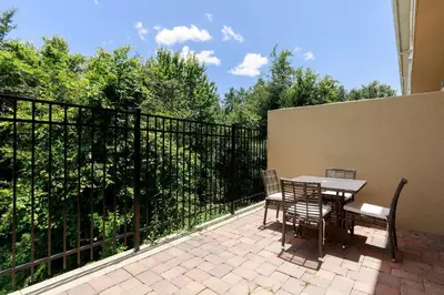 a patio with a table and chairs on a balcony at Gorgeous Dream Villa 5 min to Disney in Orlando