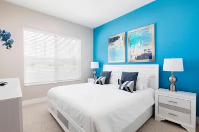 a bedroom with a white bed and blue walls at Gorgeous Dream Villa 5 min to Disney in Orlando