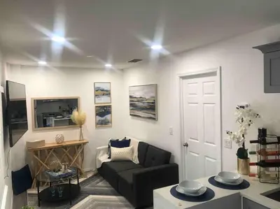 a living room with a couch and a tv at Roy's guest house in Orlando