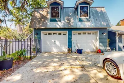 a blue house with a car parked in front of it at Dog-Friendly Apt with Fenced Yard in Winter Park in Orlando