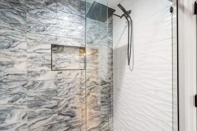 a shower with a glass door in a bathroom at Dog-Friendly Apt with Fenced Yard in Winter Park in Orlando