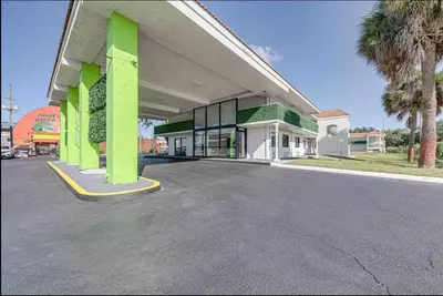 an empty parking lot in front of a building at Travel Lodge by Wyndham 10 min from Disney in Kissimmee