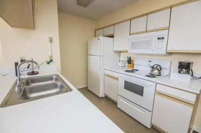 a kitchen with white appliances and a sink at Sweetwater Club 3 Bedroom Condo Resort Pool 9 Miles to Disney in Kissimmee